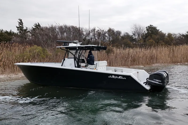 Slide: The Image of 2016 Sea Hunter 35 Tournament boat with Yamaha engines on calm water. - 13