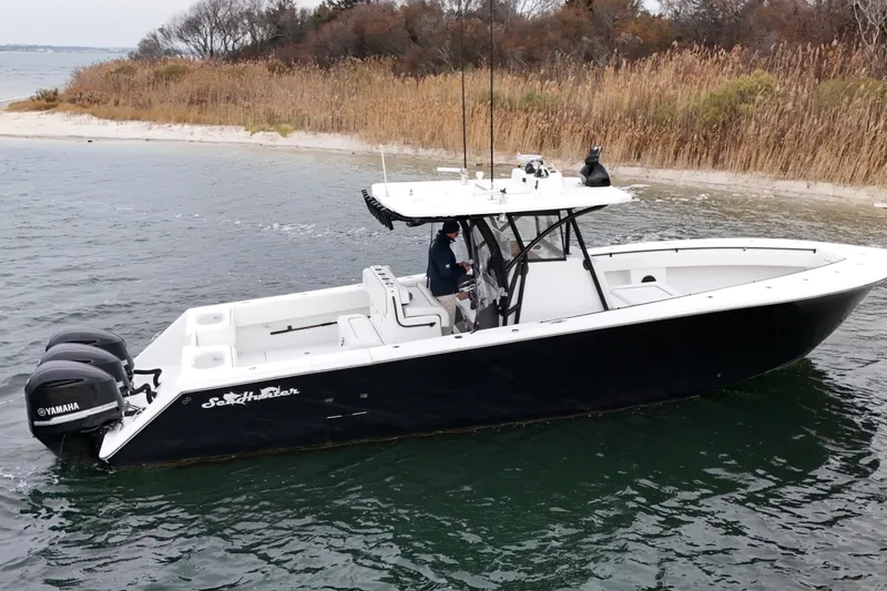 Slide: The Image of 2016 Sea Hunter 35 Tournament boat with Yamaha engines near a sandy shoreline. - 14