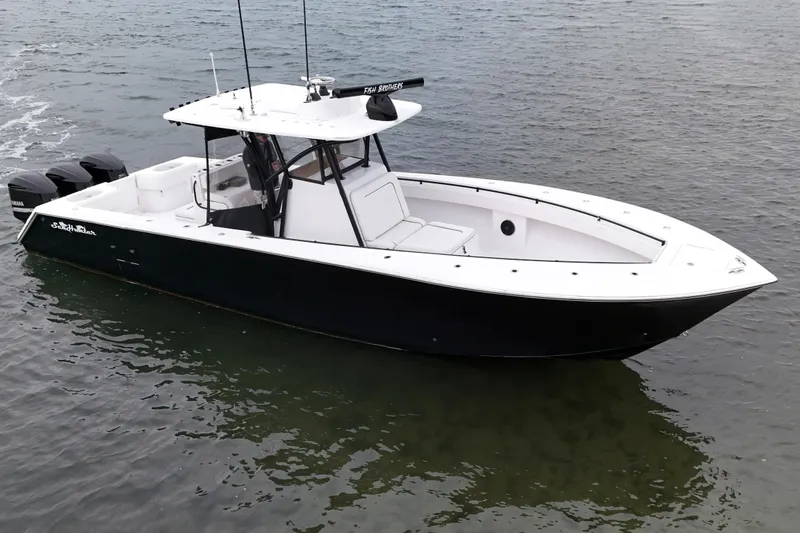 Slide: The Image of 2016 Sea Hunter 35 Tournament boat on water, featuring sleek black and white design. - 15