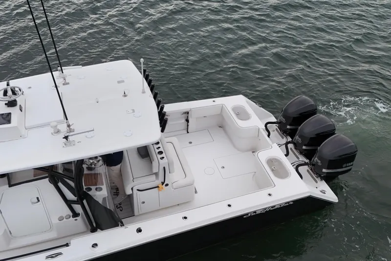 Slide: The Image of 2016 Sea Hunter 35 Tournament boat with triple Yamaha engines on the water. - 17