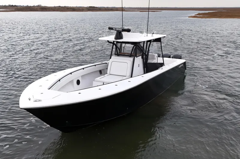 Slide: The Image of 2016 Sea Hunter 35 Tournament boat on calm water, showcasing sleek design and spacious deck. - 20