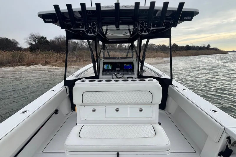 Slide: The Image of 2016 Sea Hunter 35 Tournament boat interior with white seating and navigation equipment. - 26