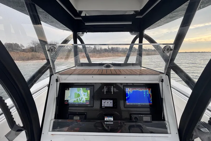 Slide: The Image of 2016 Sea Hunter 35 Tournament boat dashboard with navigation screens on open water. - 28