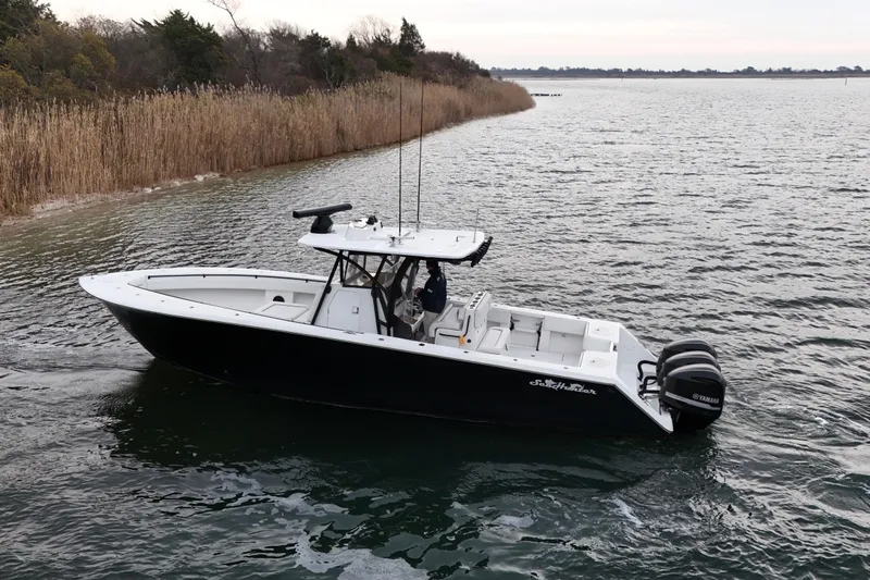 Slide: The Image of 2016 Sea Hunter 35 Tournament boat on calm water, featuring dual Yamaha engines. - 3