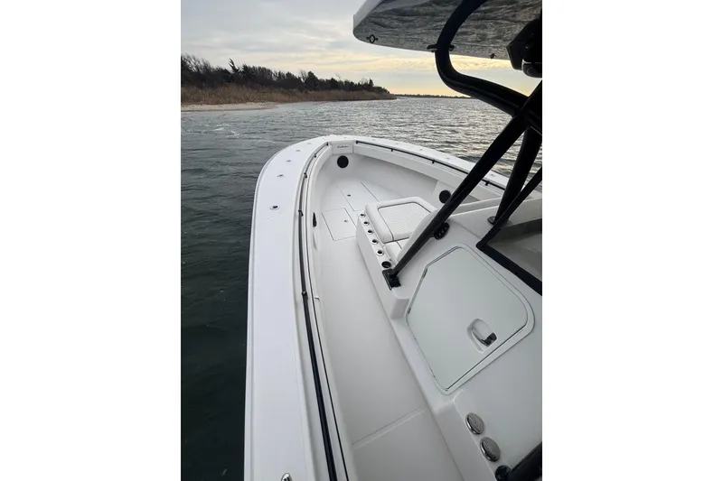 Slide: The Image of 2016 Sea Hunter 35 Tournament boat on calm waters, showcasing sleek deck design. - 31