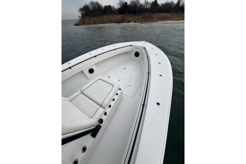 Slide: The Image of 2016 Sea Hunter 35 Tournament boat, white deck, near shoreline, calm waters. - 32