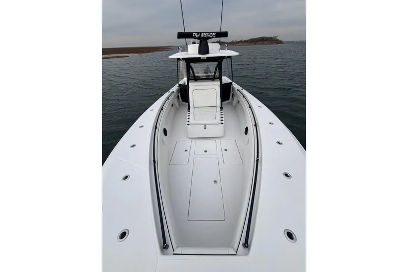 Slide: The Image of 2016 Sea Hunter 35 Tournament boat on water, showcasing spacious deck and sleek design. - 33