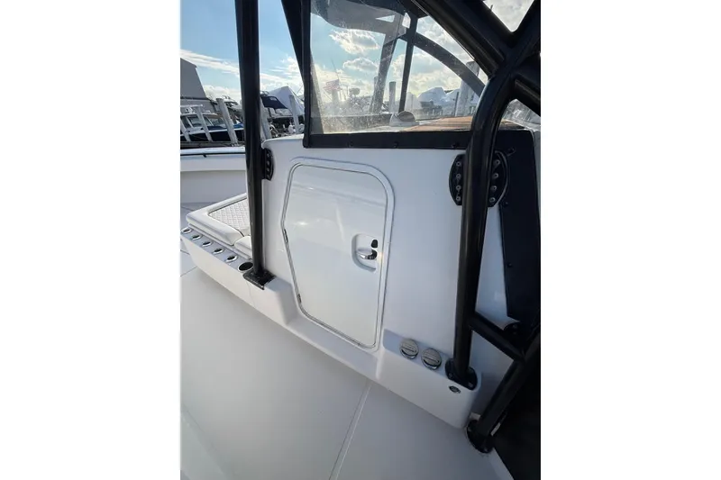 Slide: The Image of 2016 Sea Hunter 35 Tournament boat console with storage compartment and rod holders. - 38