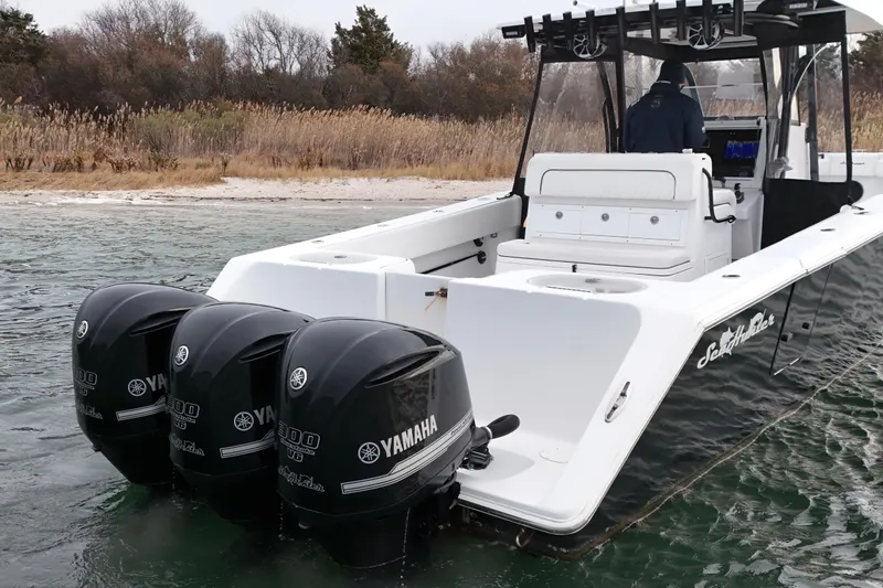 Slide: The Image of 2016 Sea Hunter 35 Tournament boat with Yamaha outboard engines near shoreline. - 4