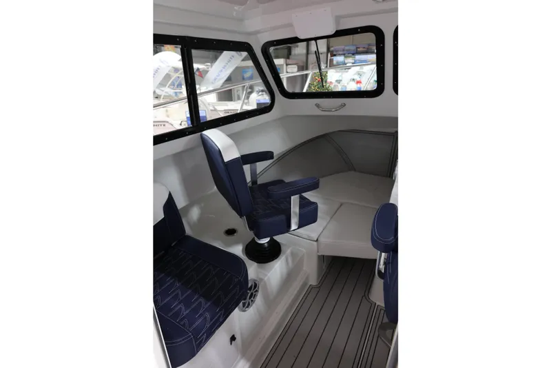 Slide: The Image of Interior of 2026 Parker 227 Explorer boat with blue seating and modern design. - 10