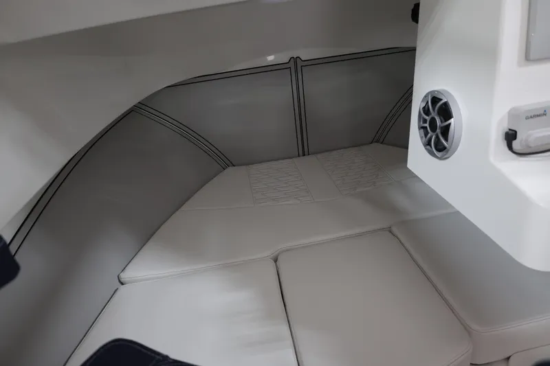 Slide: The Image of Interior cabin of 2026 Parker 227 Explorer boat with cushioned seating and speaker system. - 11