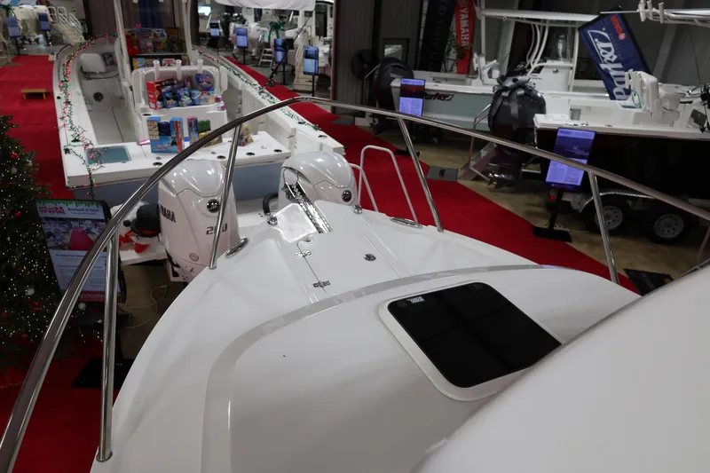 Slide: The Image of 2026 Parker 227 Explorer boat displayed at an indoor showroom with red carpet. - 14