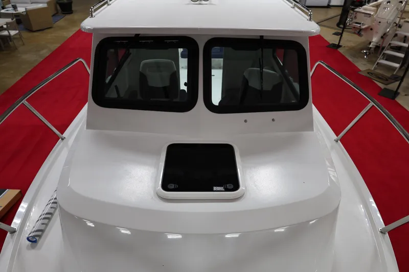 Slide: The Image of 2026 Parker 227 Explorer boat with sleek design, showcased indoors on red carpet. - 15