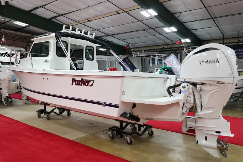Slide: The Image of 2026 Parker 227 Explorer boat displayed indoors with Yamaha outboard motor. - 3