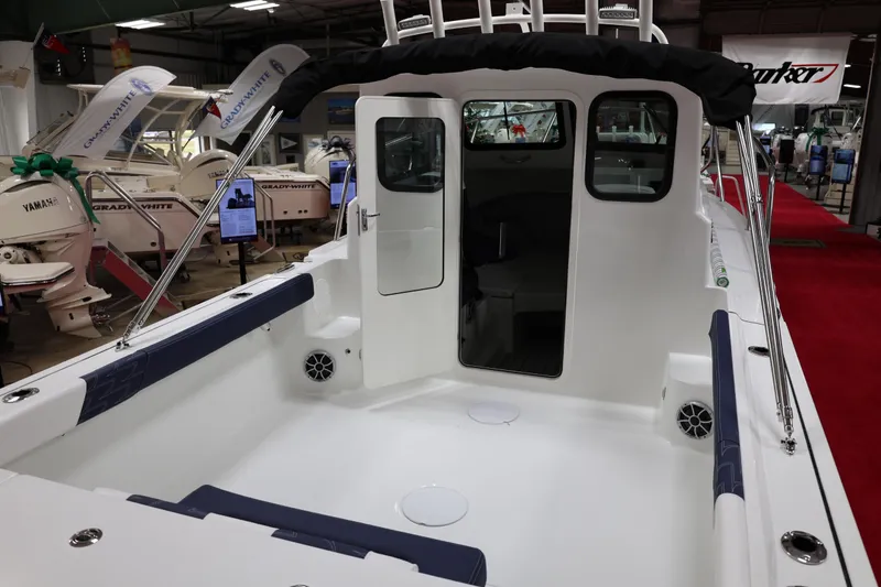 Slide: The Image of 2026 Parker 227 Explorer boat interior at a showroom, featuring spacious seating and modern design. - 5