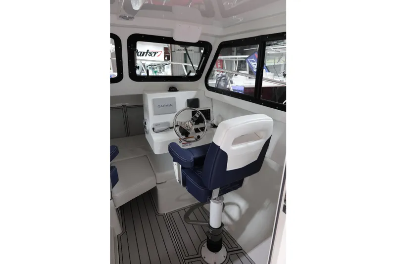 Slide: The Image of Interior of 2026 Parker 227 Explorer boat with Garmin navigation system and seating. - 9