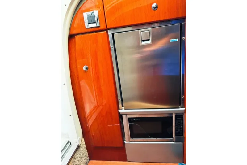Slide: The Image of 2010 Formula 310 Sun Sport interior with stainless steel fridge and microwave. - 10