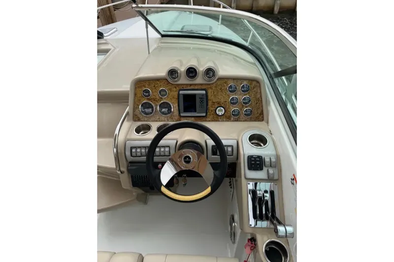 Slide: The Image of 2010 Formula 310 Sun Sport boat dashboard with steering wheel and control panel. - 11