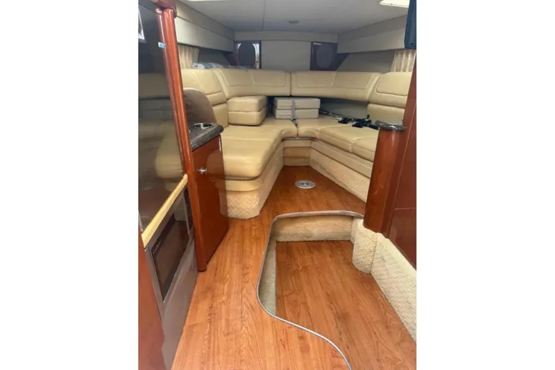 Slide: The Image of 2010 Formula 310 Sun Sport cabin with beige seating and wood flooring. - 12