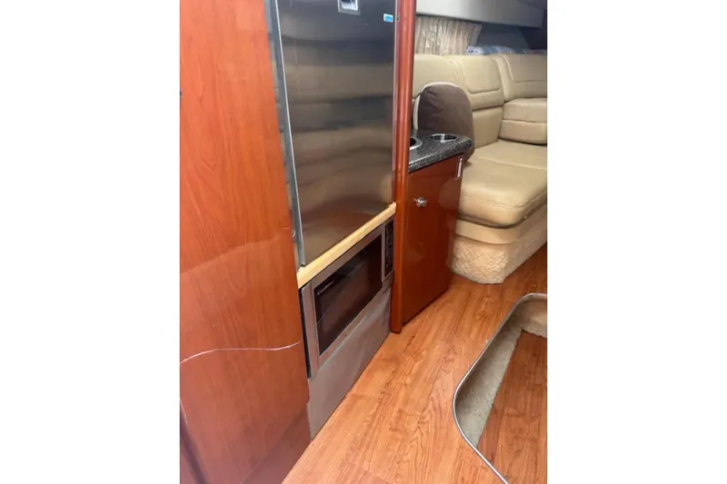 Slide: The Image of Interior of 2010 Formula 310 Sun Sport with wood finish and beige seating. - 14