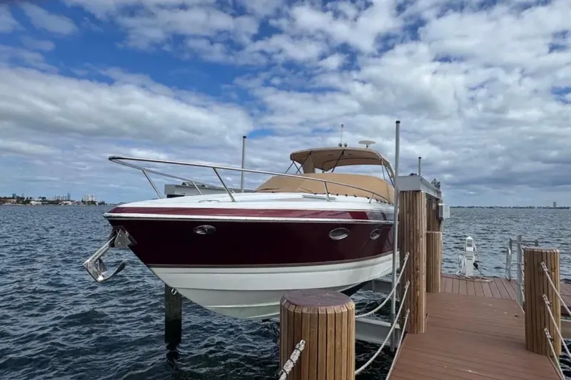 Slide: The Image of 2010 Formula 310 Sun Sport boat docked on a sunny day with cloudy sky. - 2