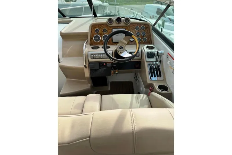 Slide: The Image of 2010 Formula 310 Sun Sport boat cockpit with steering wheel and control panel. - 3