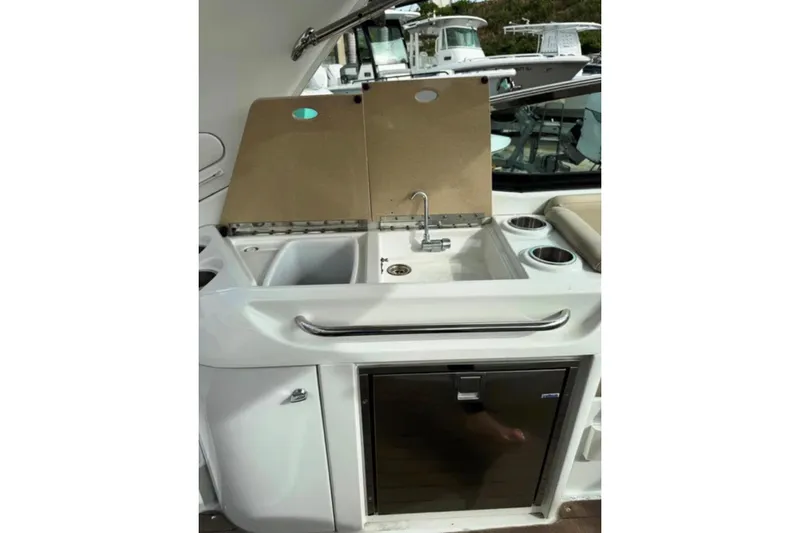 Slide: The Image of 2010 Formula 310 Sun Sport boat kitchenette with sink, faucet, and storage. - 6