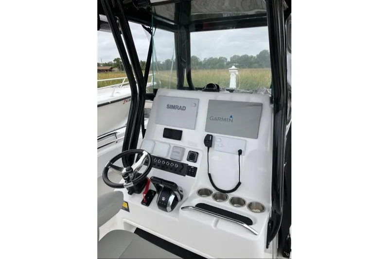 The Image of 2023 Cape Horn 27 XS boat docked at marina under clear blue sky. - 0