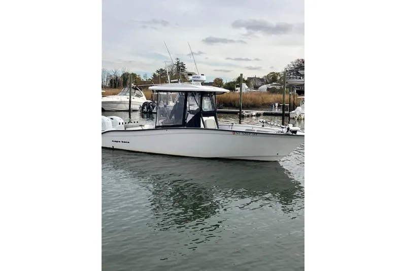Slide: The Image of 2023 Cape Horn 27 XS boat docked in a marina, overcast sky. - 2