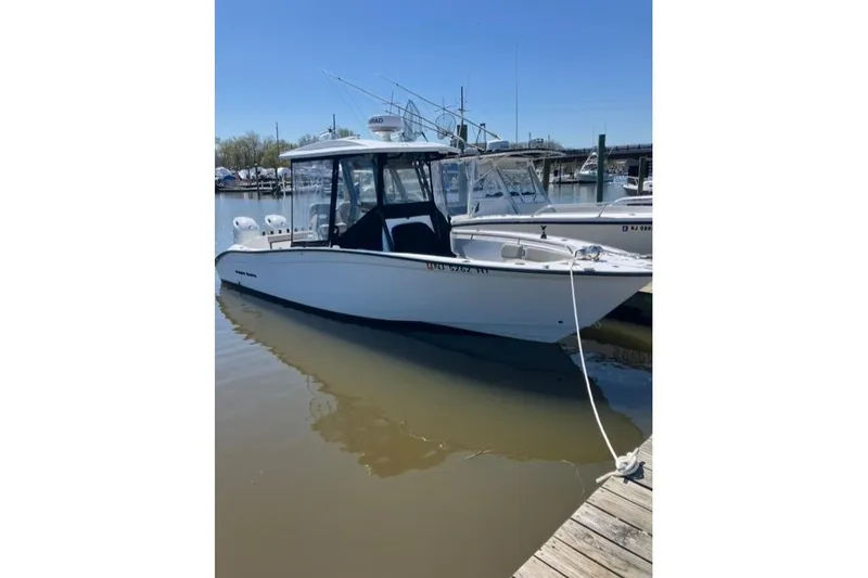 Slide: The Image of 2023 Cape Horn 27 XS boat docked in a marina under cloudy skies. - 8