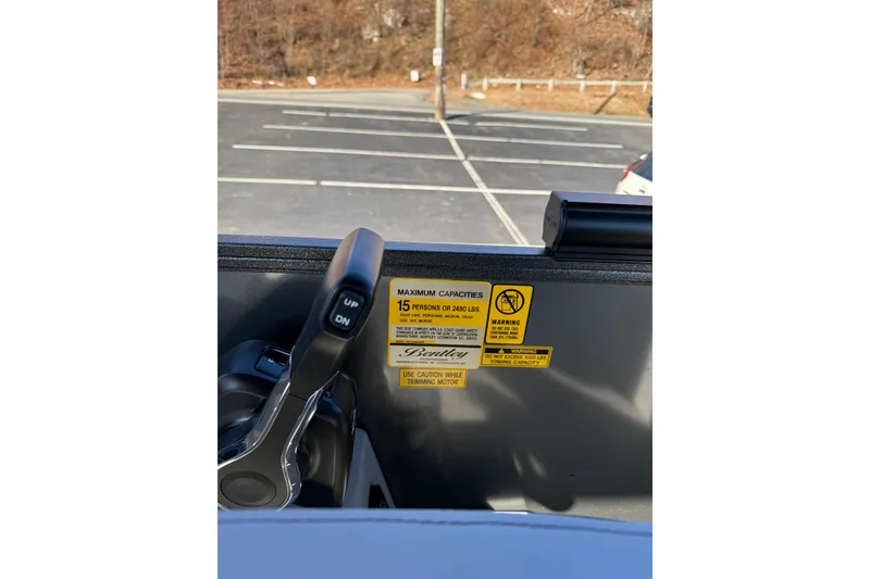 Slide: The Image of Control panel of 2026 Bentley Pontoons Legacy 223 Navigator with capacity warning labels. - 10