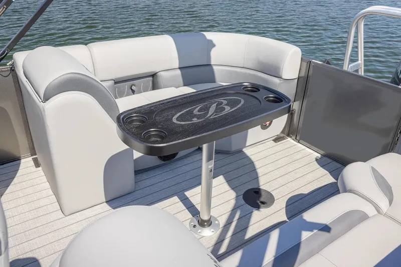 Slide: The Image of 2026 Bentley Pontoons Legacy 223 Navigator with spacious seating and canopy, docked by the water. - 4