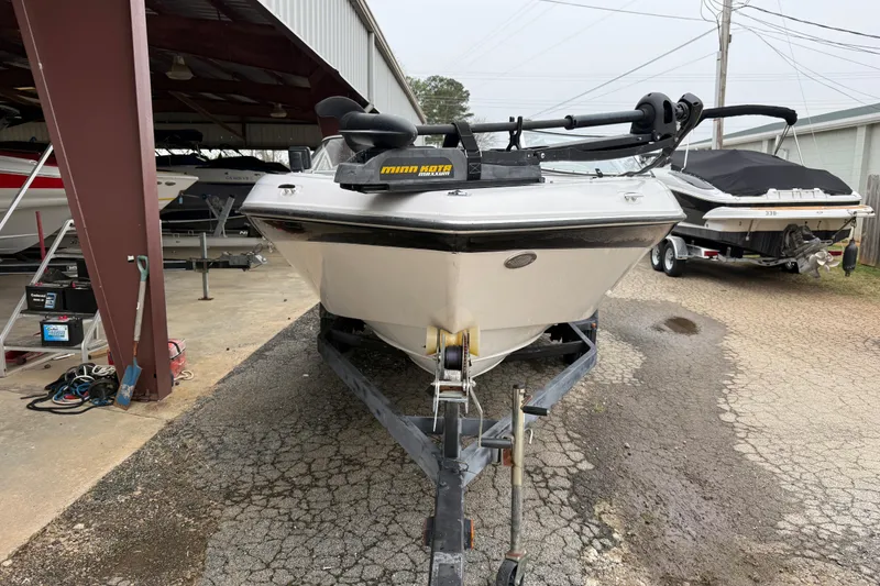 Slide: The Image of 2008 Four Winns 203 Horizon Fish & Ski boat on trailer, parked in a storage area. - 2