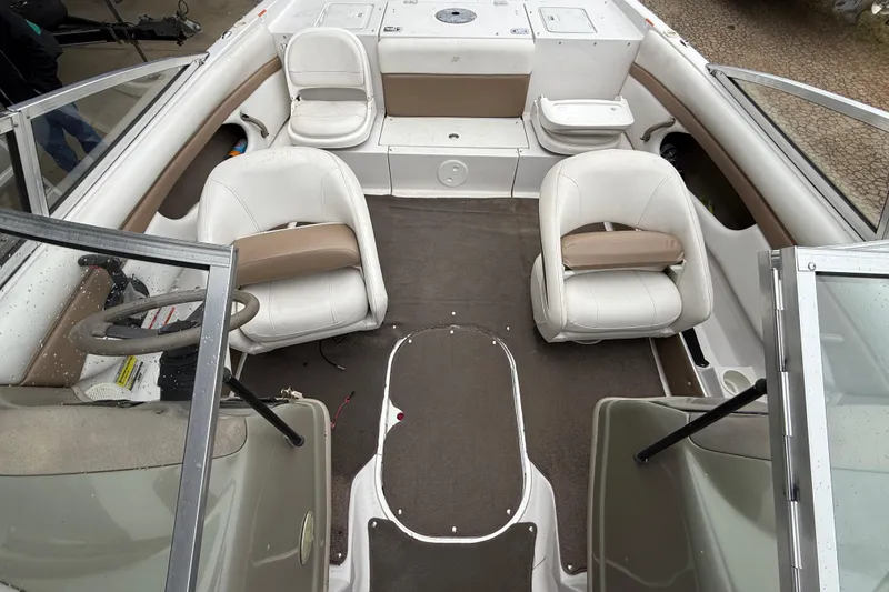 Slide: The Image of 2008 Four Winns 203 Horizon Fish & Ski boat interior with white seating and steering wheel. - 3