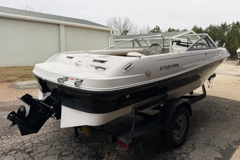 Slide: The Image of 2008 Four Winns 203 Horizon Fish & Ski boat on trailer, parked outdoors. - 9
