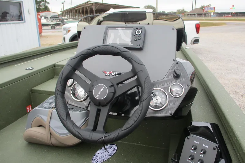 Slide: The Image of 2026 Vexus DEFENDER AVX181 boat dashboard with steering wheel and control panel. - 7