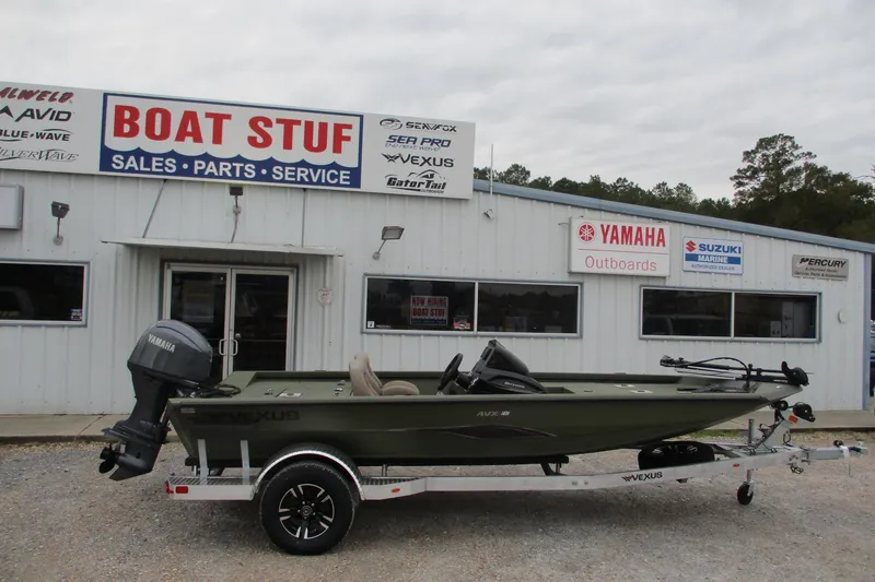 The Image of 2026 Vexus DEFENDER AVX181 boat on trailer outside dealership, featuring Yamaha outboard motor. - 0