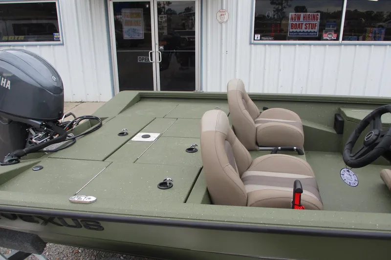 Slide: The Image of 2026 Vexus DEFENDER AVX181 boat with Yamaha engine, beige seats, and green deck. - 11