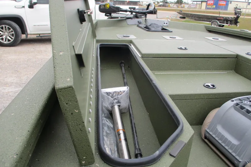 Slide: The Image of 2026 Vexus DEFENDER AVX181 boat storage compartment with equipment, parked near a vehicle. - 16