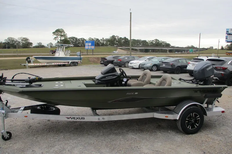 Slide: The Image of 2026 Vexus DEFENDER AVX181 boat on trailer, parked outdoors. - 2