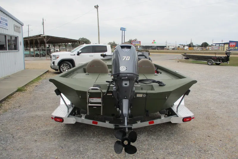Slide: The Image of 2026 Vexus DEFENDER AVX181 boat with 70 HP motor, parked on a trailer. - 4