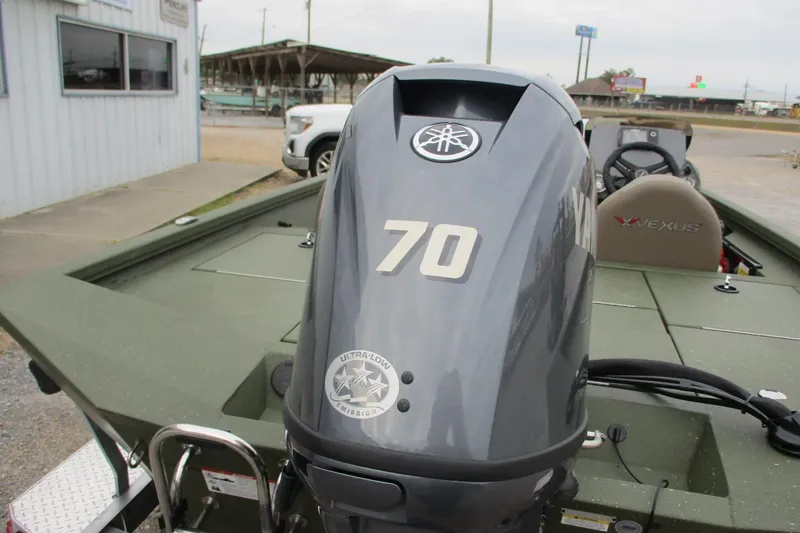 Slide: The Image of 2026 Vexus DEFENDER AVX181 boat with Yamaha 70 engine, parked outdoors. - 6