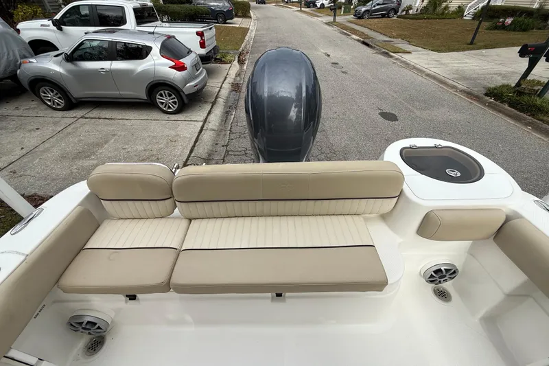 Slide: The Image of 2017 Sea Fox 226 Commander boat interior with beige seating and motor view. - 16
