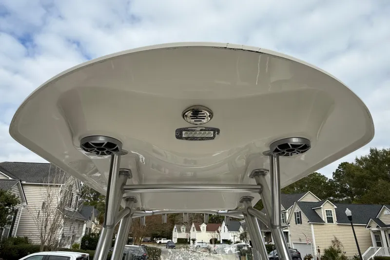 Slide: The Image of 2017 Sea Fox 226 Commander boat T-top with speakers and light, residential background. - 22