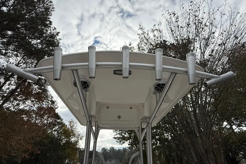 Slide: The Image of 2017 Sea Fox 226 Commander T-top with rod holders against cloudy sky. - 23