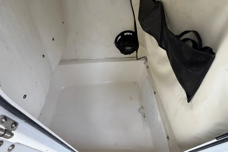 Slide: The Image of 2017 Sea Fox 226 Commander storage compartment with black mesh organizer. - 24