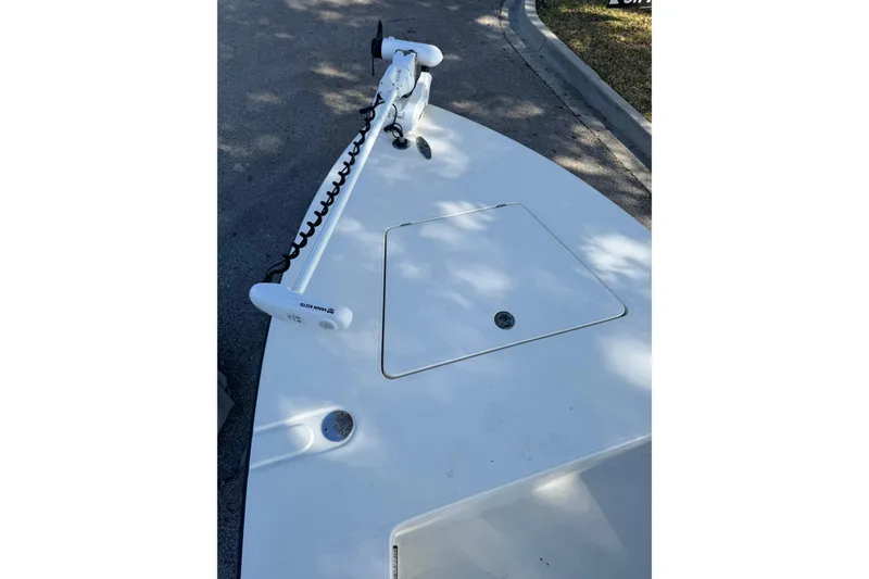 Slide: The Image of 2019 Maverick 18 HPX-V boat cruising on a serene lake. - 12