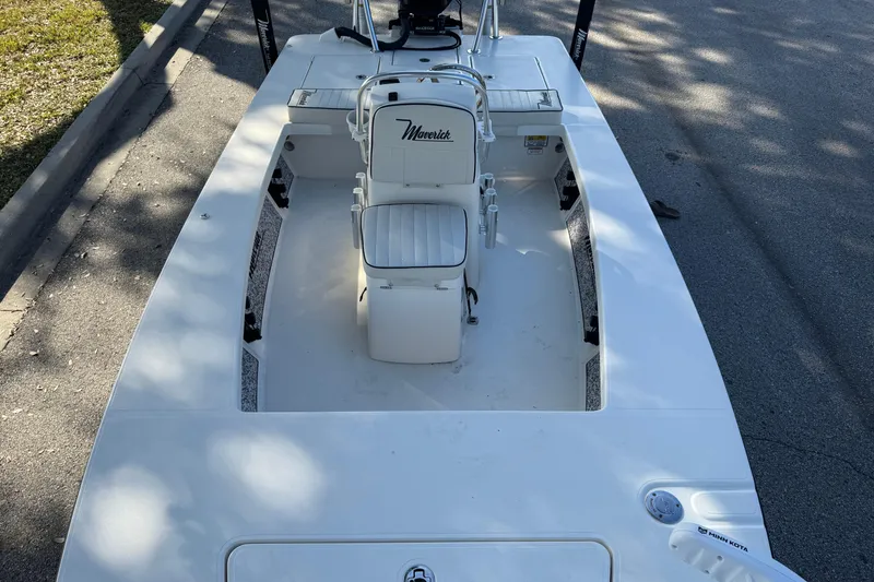 Slide: The Image of 2019 Maverick 18 HPX-V boat cruising on a calm lake with a person steering. - 14