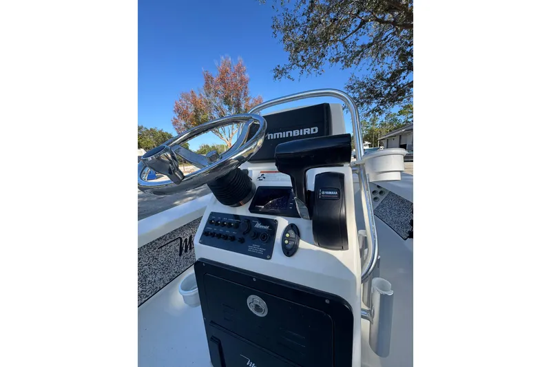 Slide: The Image of 2019 Maverick 18 HPX-V boat cruising on calm water, creating a wake. - 19