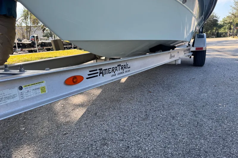 Slide: The Image of 2019 Maverick 18 HPX-V boat cruising on a calm river under clear blue skies. - 21